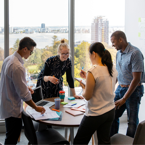 A diverse team of 4 taking part in a strategic DEI consulting conversation